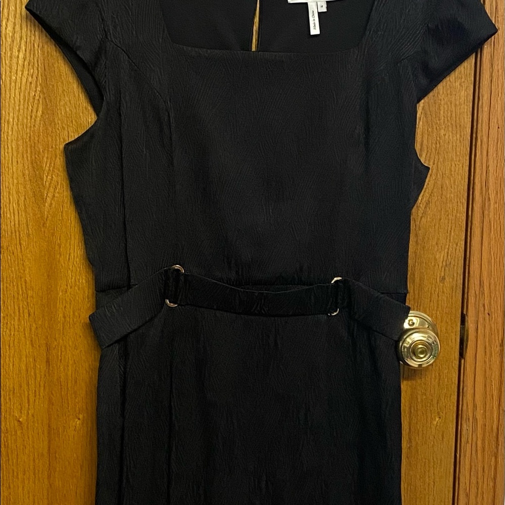 Black dress fit for any occasion. With belt, to the kneecap, new with tag.